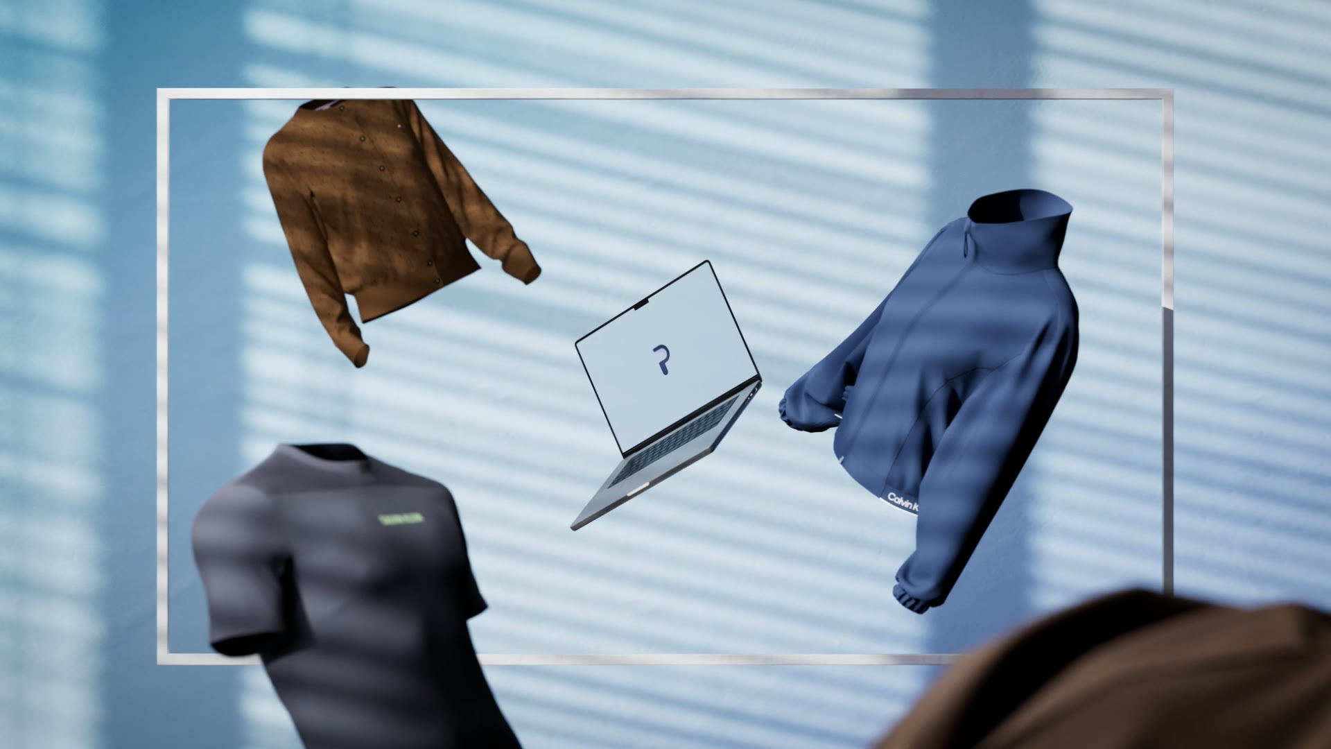 Een laptop met het Prana-logo zweeft in een lichte 3D-ruimte tussen rondvliegende kleding.
